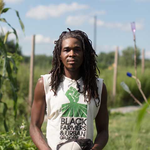An African-American man posing in a garden